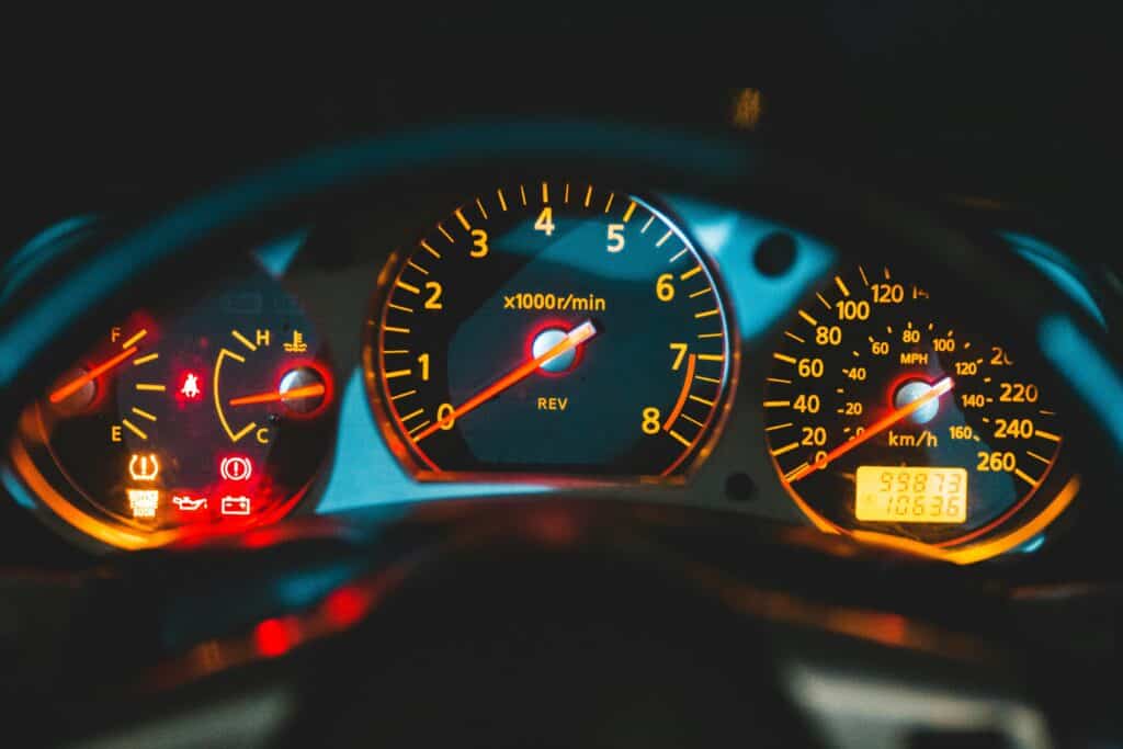 Car dashboard showing gas level, tempature, speed and RPM's.